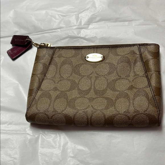 Coach Handbags - Coach Brown Clutch with Monogram Pattern and Zipper Closure